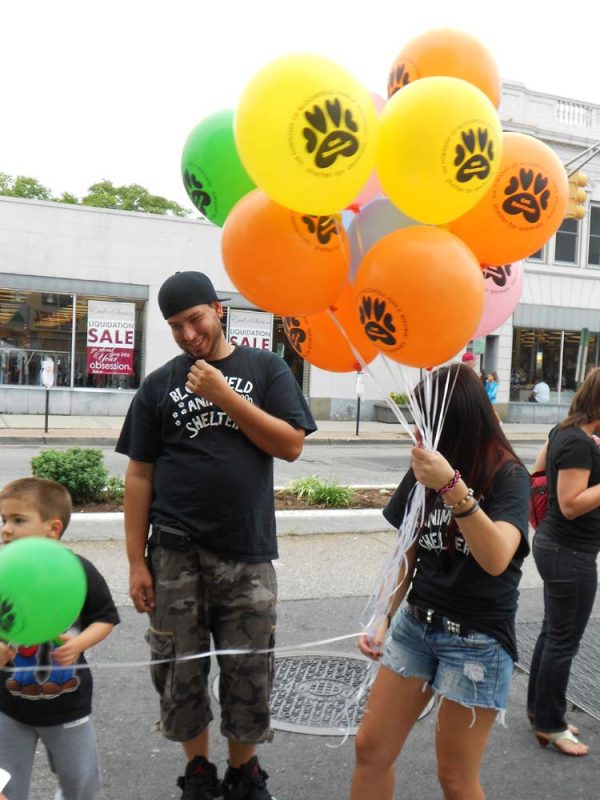 Woman handing out custom printed balloons